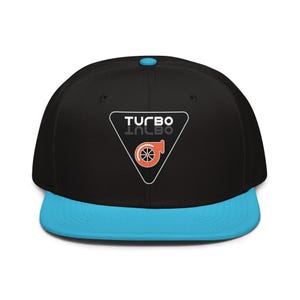 May include: Black baseball cap with a light blue peak and button. The cap displays a white triangle with the word "TURBO" and an orange turbocharger graphic.