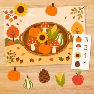 May include: An educational autumn-themed activity sheet featuring a woven basket filled with pumpkins, mushrooms, corn, and a sunflower. A vertical card displays counts for pumpkins, mushrooms, sunflowers, and pinecones. Loose cutouts include a pumpkin, gourd, pinecone, corn, and apple.