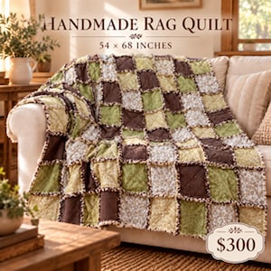 May include: A handmade rag quilt featuring a patchwork design of brown, sage green, and cream floral patterned fabric squares. The quilt measures 54 by 68 inches and has exposed frayed seams between each square, creating a textured, layered appearance.