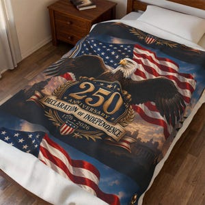 May include: A blanket with a design celebrating the 250th anniversary of the Declaration of Independence. It features the American flag, a bald eagle, and the text '250th Anniversary Declaration of Independence 1776-2026'. The colour scheme is red, white, and blue.