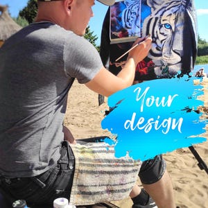 May include: A black leather jacket featuring a hand-painted white tiger with striking blue eyes, surrounded by red roses and blue smoke accents. The artwork is displayed on a jacket being painted with a brush, with paint jars nearby.