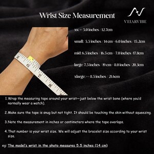 May include: A wrist size measurement guide featuring a white measuring tape wrapped around a wrist. Text includes: Wrist Size Measurement, VELARVIBE, size ranges from xs to xlarge in inches and cm, and four instructional steps for measuring.