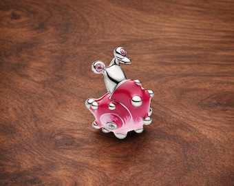 May include: A silver and pink snail charm with a detailed design. The charm features a pink body with silver accents and two pink crystal embellishments. The snail's shell has a textured appearance.