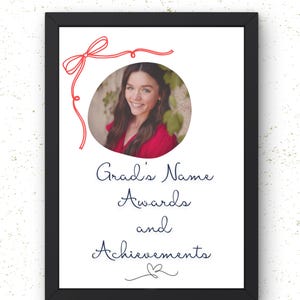 May include: A framed print with a black border features a photo of a person in a red top, surrounded by a red bow and the words "Grad's Name Awards and Achievements" in elegant script.