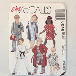 May include: A McCall's 6246 sewing pattern envelope for children's sleepwear in size extra-small. The cover features illustrations of various pajamas, including striped sets, a star-print nightshirt, a martial arts style set, and plaid robes.