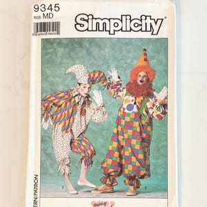 May include: A Simplicity sewing pattern envelope, number 9345, size MD. The front features two clown costumes: one with a diamond-patterned jester hat and outfit, and another with a colorful checkered jumpsuit, orange wig, and a ruffled collar.