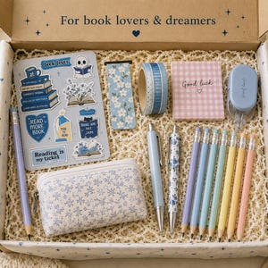 May include: A stationery gift box labelled For book lovers & dreamers containing a sticker sheet, a floral bookmark, blue washi tape, a pink checkered notepad, a correction tape, a floral pencil case, two pens, and six pastel coloured pencils.