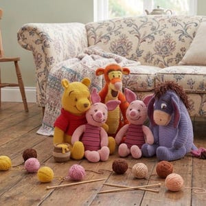 May include: A collection of handmade Winnie the Pooh character plush toys, including Winnie the Pooh, Piglet, Tigger, Eeyore, and two Piglets. The toys are made of yarn and are arranged on a wooden floor with yarn balls and knitting needles.
