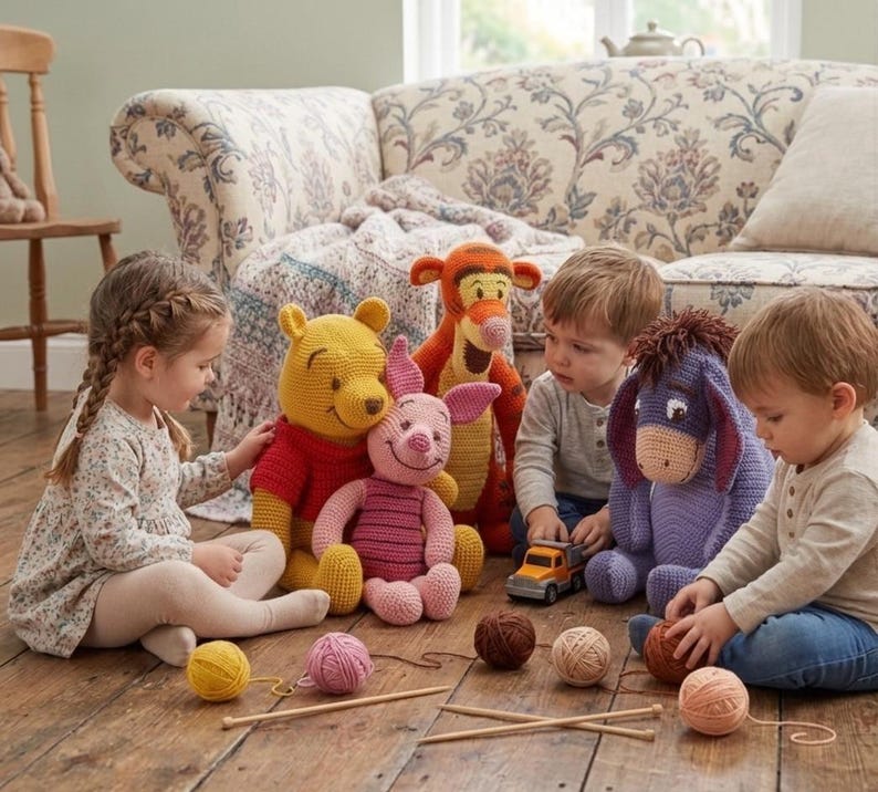 May include: A collection of handmade Winnie the Pooh character plush toys, including Winnie the Pooh, Piglet, Tigger, and Eeyore. The toys are made of yarn and are in a variety of colors, including yellow, pink, orange, and purple. The toys are sitting on a wooden floor.