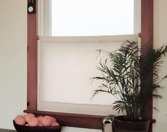 May include: A window with a cream-colored fabric cafe curtain, framed by dark wood trim. A black thermometer is mounted on the left side of the frame. A dark wooden bowl filled with pinkish-orange fruits sits on a dark table next to a potted palm.