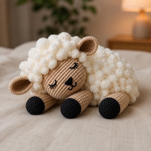 May include: A crocheted stuffed sheep toy featuring a textured white woolly body, a tan face with closed eyes and a black nose, and tan ears. The sheep has four legs with tan upper sections and black lower sections, all crafted in a soft yarn material.