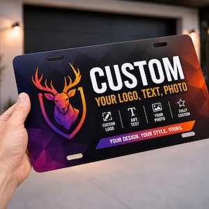 May include: Custom license plate with a geometric deer logo in orange, purple, and yellow. The plate features the text "CUSTOM" and options for logo, text, and photo. The design includes the text "YOUR DESIGN. YOUR STYLE. YOURS."