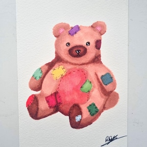 May include: A watercolour painting of a brown teddy bear with a large red heart patch on its chest and various colourful patches in yellow, green, blue, pink, and purple on its limbs and head. The bear has dark eyes and a signature in the corner.