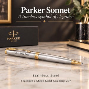 May include: A Parker Sonnet ballpoint pen with a brushed stainless steel finish and gold-colored accents. The pen features the engraved text 'Best Dad Ever' on the barrel and a gold clip. The pen is presented with its black Parker branded box.