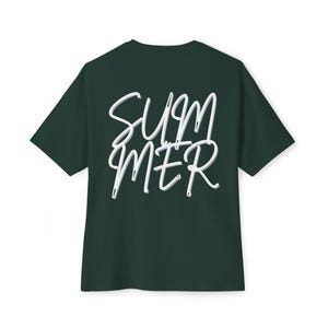 Peut inclure: Un t-shirt à manches courtes vert forêt foncé avec le mot "SUMMER" imprimé en lettres manuscrites blanches avec un léger effet d'ombre portée gris, centré au dos du vêtement qui présente une encolure ronde classique.