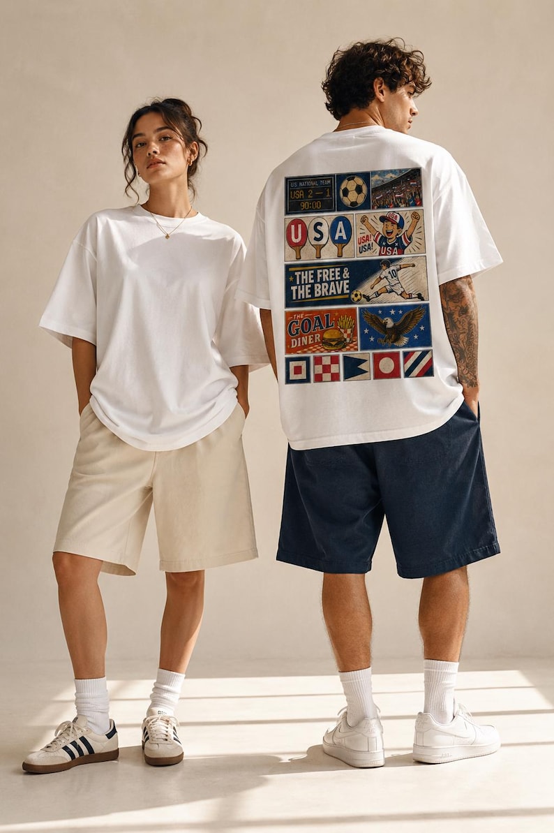 May include: Two people wearing white t-shirts and shorts. One shirt has a graphic on the back with the text "USA", "THE FREE & THE BRAVE", and "GOAL DINER". The other person wears a plain white t-shirt and beige shorts. Both wear sneakers.