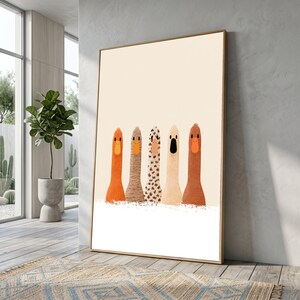 May include: A framed wall art print featuring five stylised, long-necked bird figures in a row against a cream background. The figures have distinct textures and colours, including solid orange, tan, spotted, light beige, and dark brown, all with orange beaks.