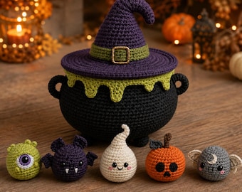 May include: A black crocheted cauldron with a purple witch hat lid featuring a green band and gold buckle. Five small crocheted figures sit in front: a green one-eyed creature, a purple bat, a white ghost, an orange pumpkin, and a gray bat.