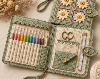 May include: A sage green crochet organizer case featuring a daisy motif cover, a wrist strap, and a button closure. The interior contains slots for eleven colorful crochet hooks, a pair of scissors, a small pocket, and a white measuring tape.