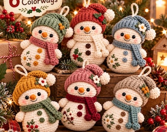 May include: Six crocheted snowman ornaments with white bodies, each wearing a unique colored hat and scarf. The snowmen feature embroidered floral details, small buttons, and hanging loops. A sign above reads 6 Adorable Colorways.