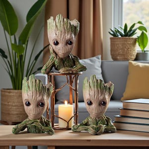 May include: Three Groot-shaped planters in a home setting. The planters are brown and green, with a textured, wood-like appearance. One planter rests on a decorative metal stand with a lit candle. Other plants and books are also visible.