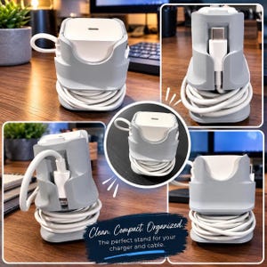 May include: A light gray plastic charger organizer stand featuring a central slot for a white power adapter and a wrap-around base for cable management. The stand displays a white charging cable coiled neatly around the base, with the connector visible.