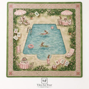 May include: A square textile mat featuring a watercolor illustration of rabbits at a swimming pool, surrounded by a pink and green lattice border. Scattered mahjong tiles are visible, and the bottom center displays the text Tiles for Four.