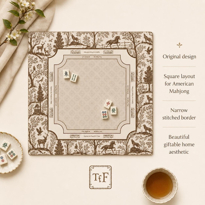 May include: A square American Mahjong mat featuring a brown and cream toile-style print of forest animals and trees. The center play area includes printed instructions for the Charleston, with four Mahjong tiles placed on the surface.