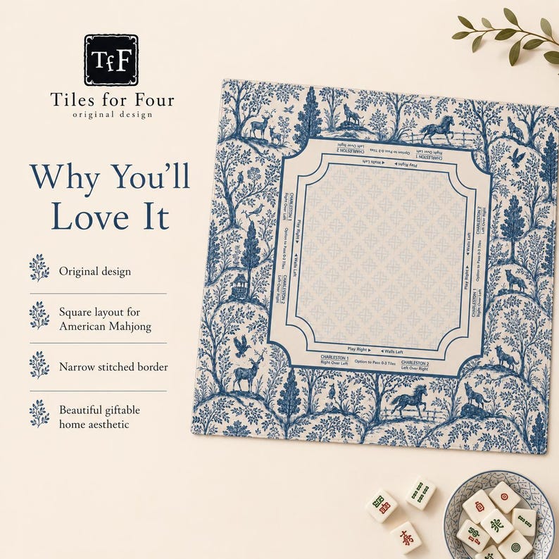 May include: A square American Mahjong mat featuring a blue and white toile pattern of trees and animals. The center includes printed game instructions and directional markers. A small bowl with white Mahjong tiles sits nearby on the surface.