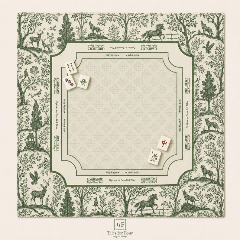 May include: A square game mat featuring a green and cream toile-style forest pattern with animals and trees. The center includes printed instructions for Charleston gameplay, with four mahjong tiles placed on the surface. The text reads Tiles for Four.