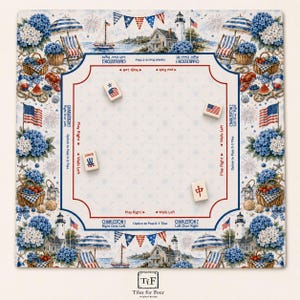 May include: A square Mahjong mat featuring a nautical theme with lighthouses, sailboats, beach chairs, and blue hydrangeas. The center play area includes printed instructions for Charleston rules and four tiles with American flag and Joker designs.