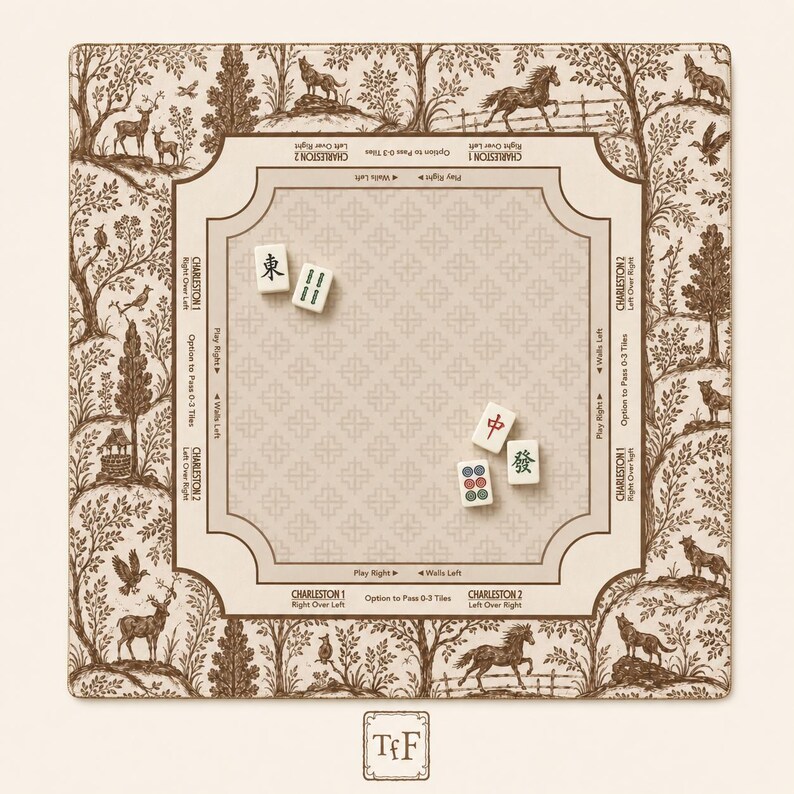 May include: A square Mahjong mat featuring a cream-colored center with a repeating cross pattern and brown border text detailing Charleston rules. The outer edge displays a brown and cream toile-style forest scene with animals. Four Mahjong tiles are placed on the mat.