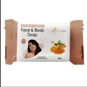 May include: A rectangular bar of Byenblan Turmeric Face & Body Soap in white packaging with brown ends. The label features the text Byenblan Turmeric Face & Body Soap, a graphic of a person, a wooden scoop with turmeric powder, and the weight 4oz.