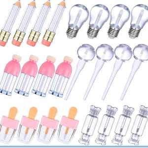May include: A collection of empty lip gloss containers in various shapes including pencils, light bulbs, lollipops, bottles, popsicles, and candies. Each container is clear with a wand applicator and features distinct colored caps or bases.