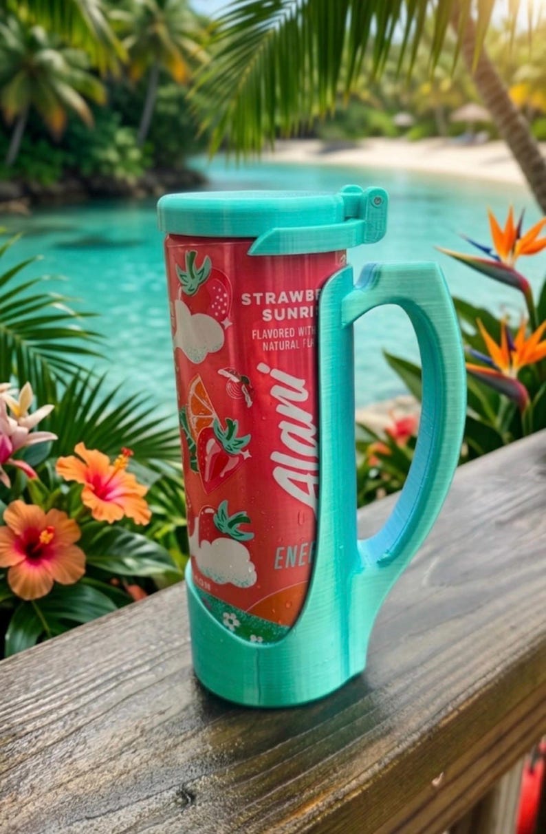 May include: A teal 3D-printed plastic can holder with a handle and a hinged lid, securely holding a red Alani Strawberry Sunrise energy drink can. The can features graphics of strawberries and orange slices with the text Alani Energy.