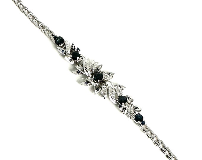 Elegant Sterling Silver Bracelet with Floral Spray Design and Sapphire Accents