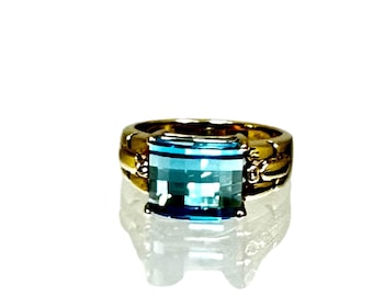 Stunning 14 Karat Yellow Gold Ring Set with a Blue Topaz with Checkerboard Faceting