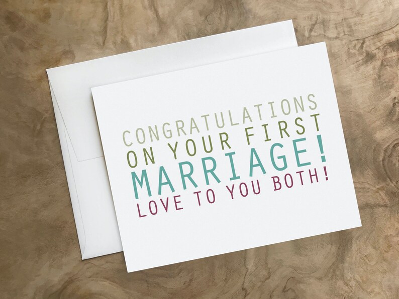May include: A white card with the text "Congratulations on your first marriage! Love to you both!" in colorful lettering.
