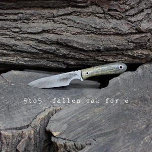 May include: A set of three ceramic mugs with a speckled, matte finish. The mugs are in shades of cream, light gray, and dark gray. Each mug has a simple, minimalist design, perfect for coffee or tea.