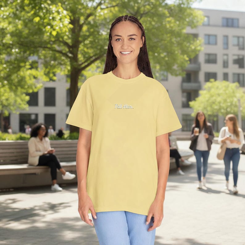 May include: A pale yellow short-sleeved t-shirt featuring the text "Talk later." embroidered in small white letters on the centre of the chest. The garment has a crew neckline and a relaxed fit, constructed from a solid-coloured fabric.