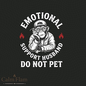 May include: Black graphic tee featuring a cartoon monkey wearing glasses and a backwards cap. The text reads "EMOTIONAL SUPPORT HUSBAND DO NOT PET" in a circular design. Red flame icons flank the monkey image.