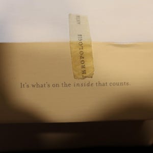 Pu&ograve; includere: Una scatola bianca con una fascia color beige e la scritta "It's what's on the inside that counts." Un'etichetta verticale con la parola "ANTHROPOLOGIE" &egrave; apposta sulla scatola. La scatola &egrave; chiusa e pronta per la spedizione.