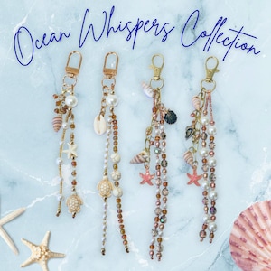 May include: Four beaded keychains from the Ocean Whispers Collection featuring gold-tone lobster clasps, white faux pearls, brown glass beads, and various charms including miniature sea turtles, starfish, and small seashells in tan and pink.