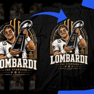 May include: A black t-shirt featuring a graphic illustration of a football player in a white jersey holding the Vince Lombardi Trophy. The text reads LOMBARDI THE STANDARD WORLD CHAMPIONS with a blue arrow pointing toward the shirt design.