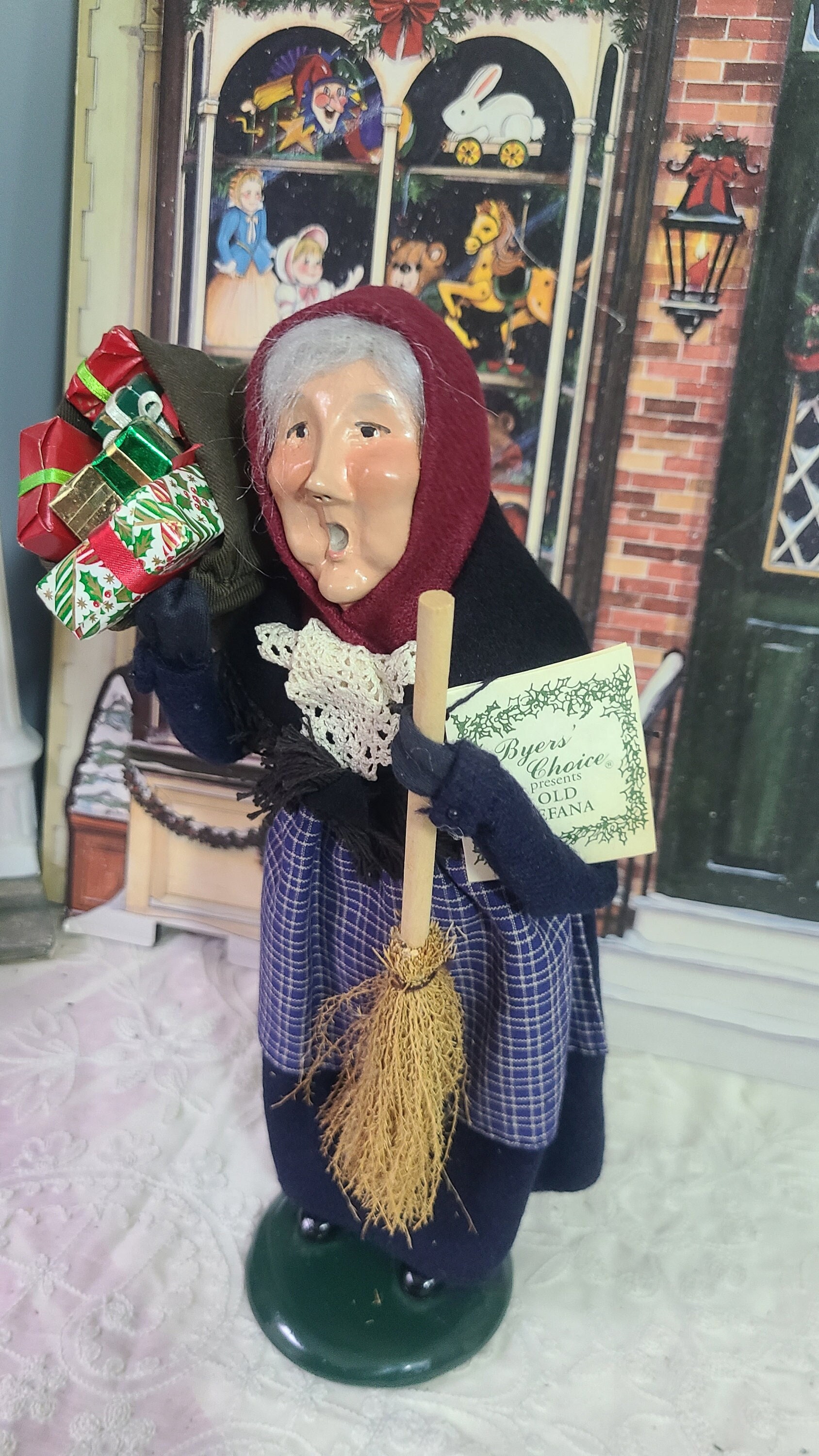 Befana Old Woman Flying On A Broomstick With A Basket Of Gifts For