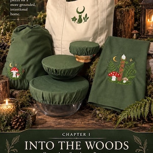 May include: A collection of olive green fabric items including a drawstring bag, three bowl covers, and a rectangular cloth, all featuring embroidered nature motifs like mushrooms and ferns, alongside a cream-colored tote bag with a cat and moon logo.