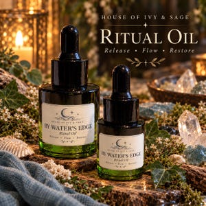 May include: Two dark green glass dropper bottles labeled House of Ivy & Sage Ritual Oil By Water's Edge. The labels feature a crescent moon, stars, and the text Release, Flow, Restore. The bottles have black caps and are positioned together.