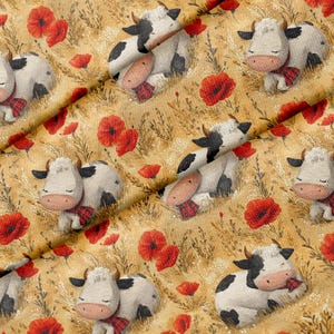 May include: Fabric featuring a repeating pattern of cartoon cows with closed eyes and pink snouts, each wearing a small red plaid scarf. The cows are set against a golden yellow background filled with red poppy flowers and thin brown grasses.