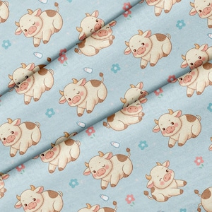 May include: A light blue fabric featuring a repeating pattern of cartoon cows with cream-colored bodies and brown spots. The cows are depicted in various poses, interspersed with small pink flowers, blue flowers, and white baby bottles.