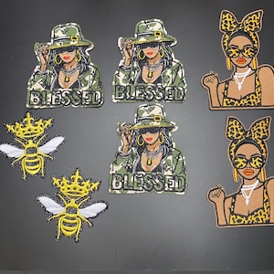 May include: Embroidered patches featuring a woman in a camouflage jacket and hat, with the word "BLESSED" below. Also, patches of a woman with a leopard print bow and sunglasses, and two bee patches with crowns.